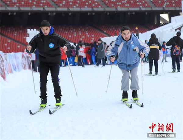 来自北京市昌平二中的维吾尔族学生帕尔哈提(右)和希尔扎提练习滑雪