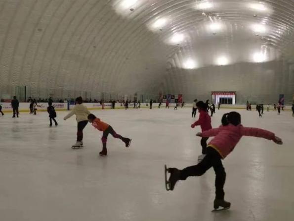 孩子们在哈尔滨名将冰上运动中心里学习花样滑冰